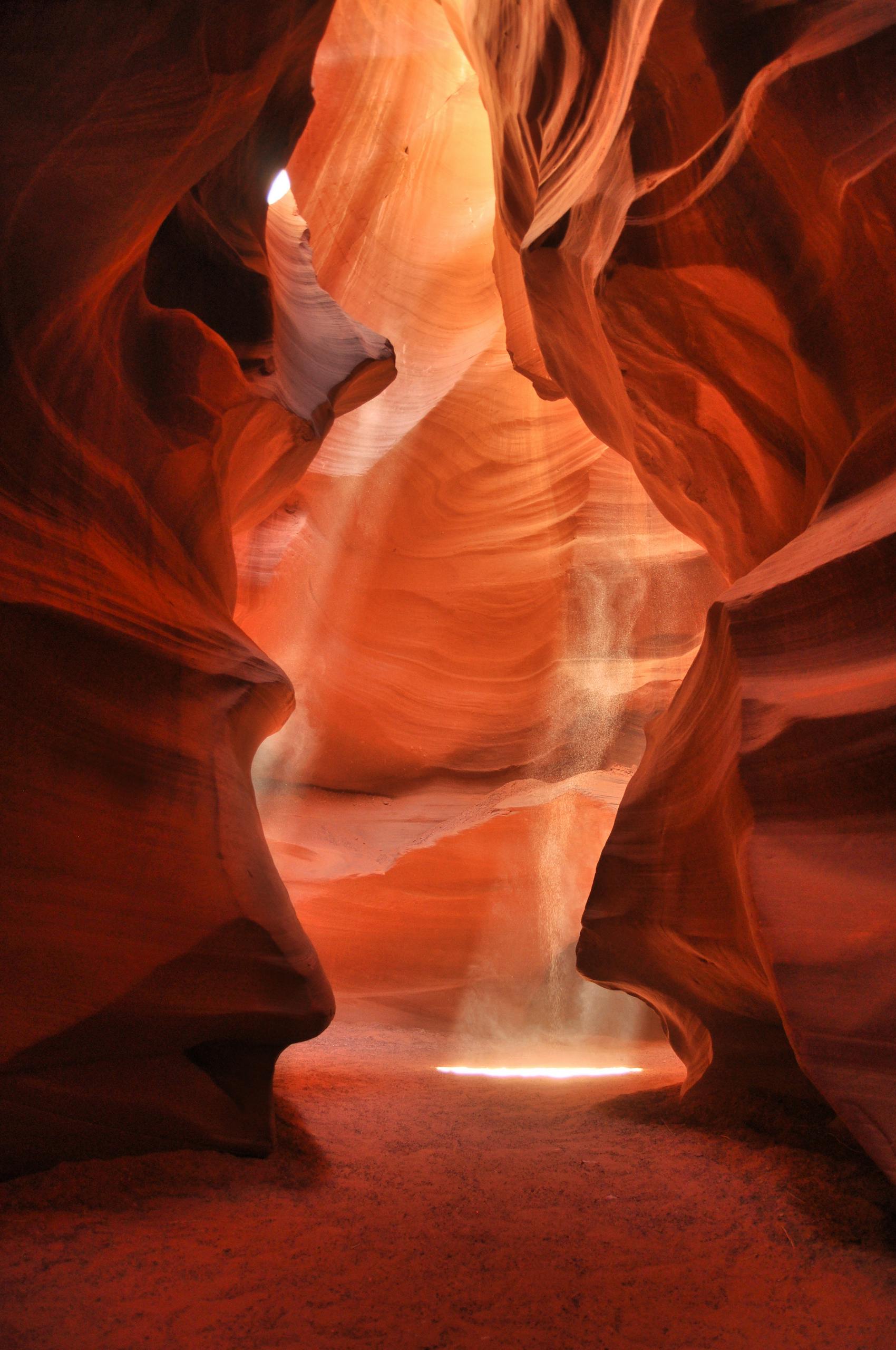 1:1 Breathwork Session Stunning sunrays illuminate the narrow sandstone passages of Antelope Canyon in Arizona.